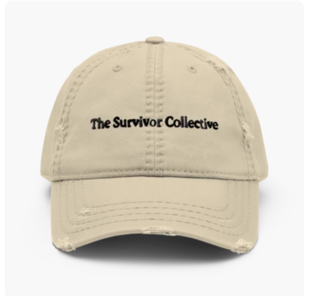 Distressed tan dad hat with The Survivor Collective wordmark
